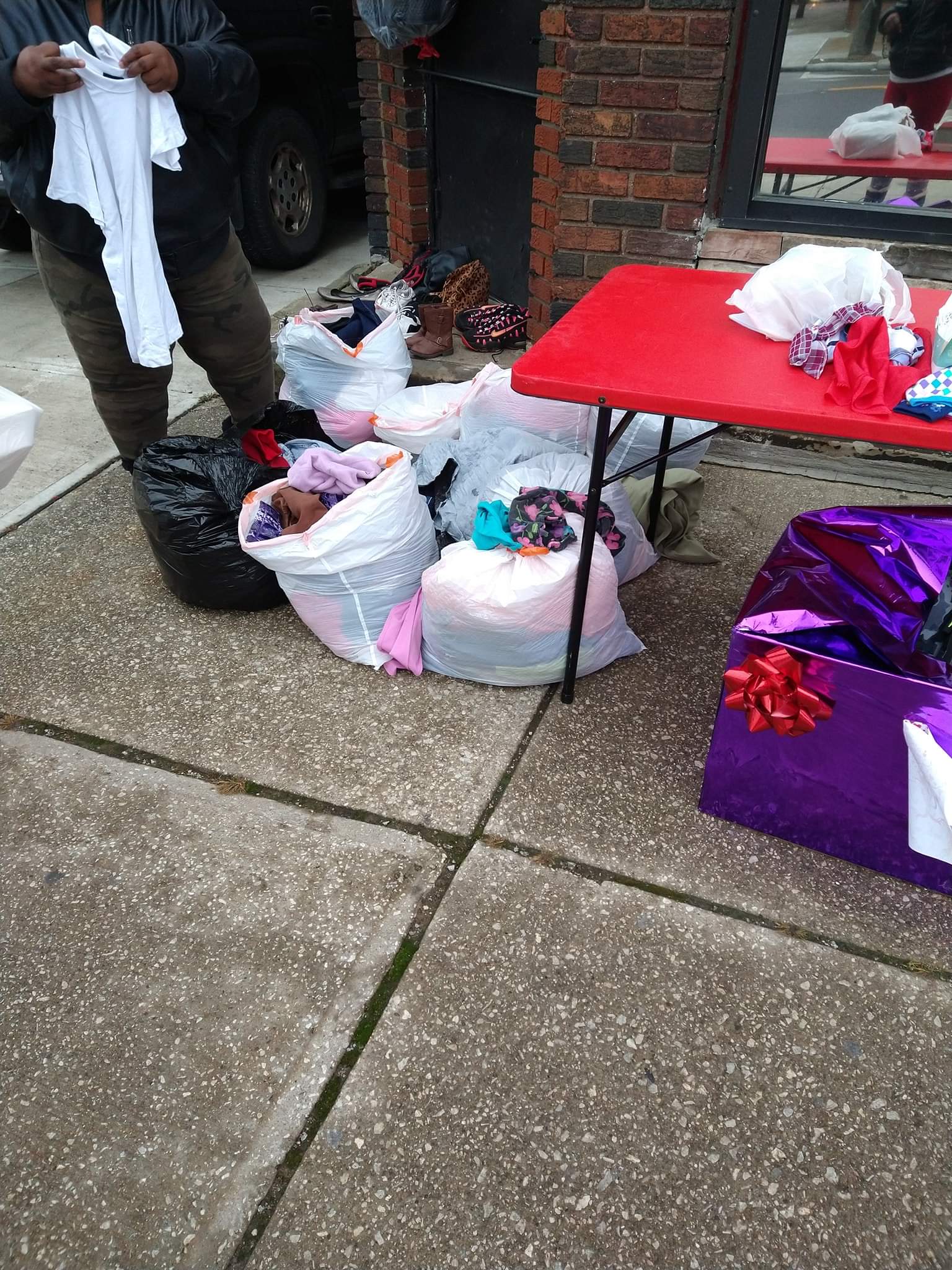 A red table sitting on top of a sidewalk